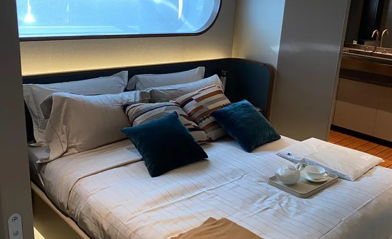 Luxurious bedroom interior of 2024 Azimut Magellano 30M yacht with modern design.